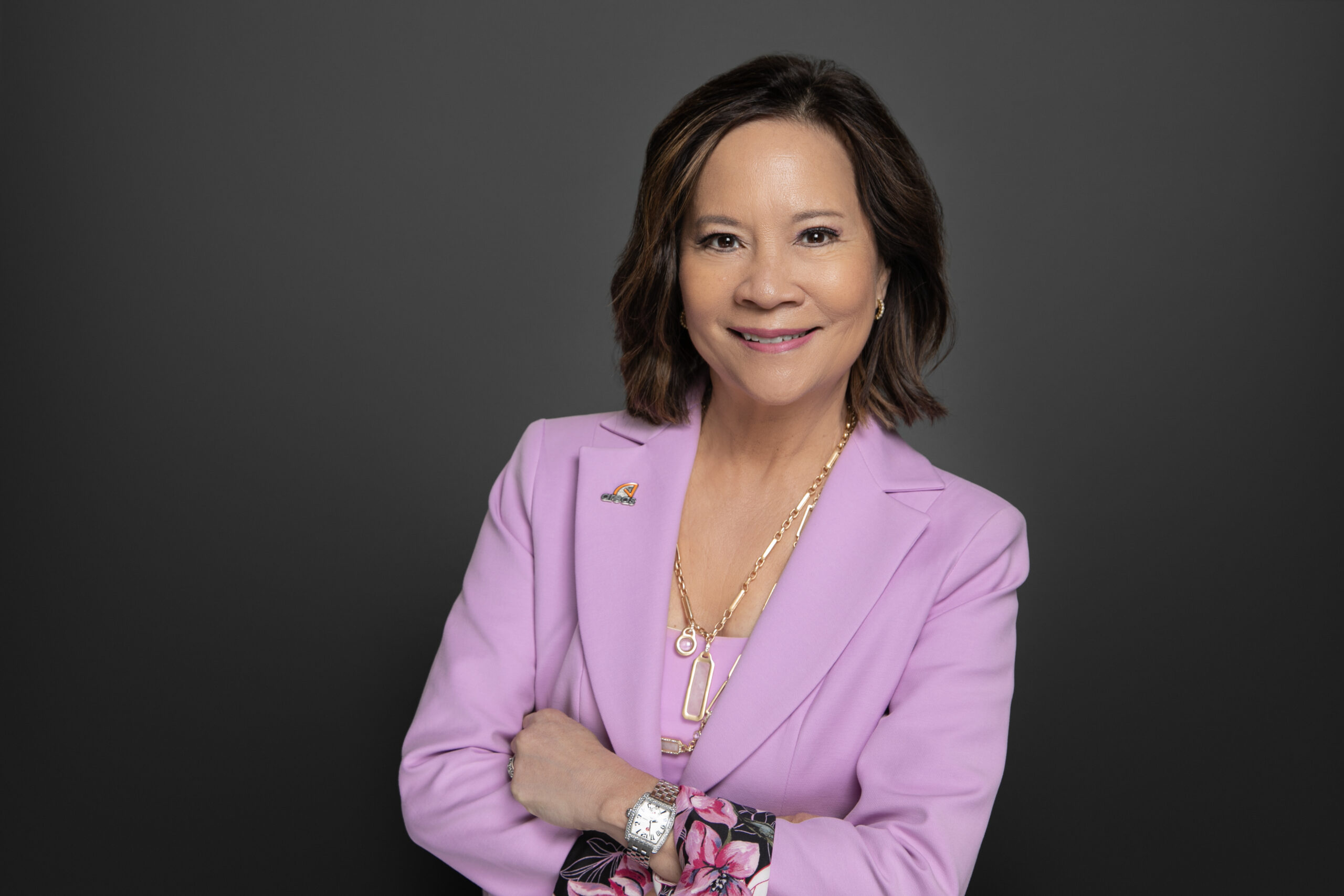 A woman wearing pink and posing for a picture